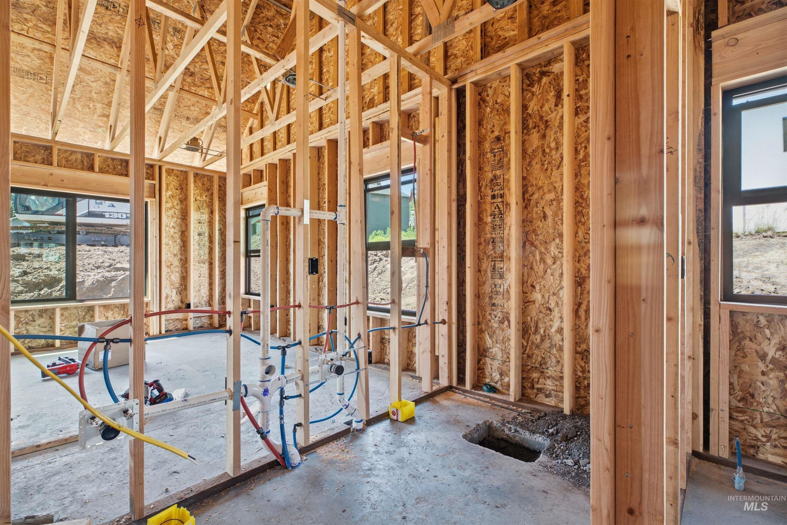 2824 Cyprus Court Moscow, ID 83843 - Photo 7 of 20 New construction framing with exposed plumbing lines and multiple window openings