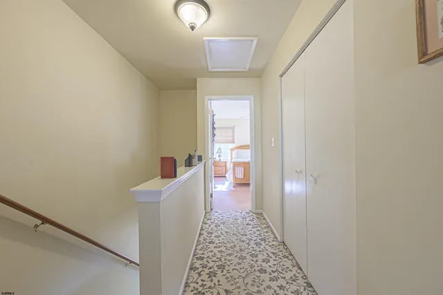 a hallway with a door and couch