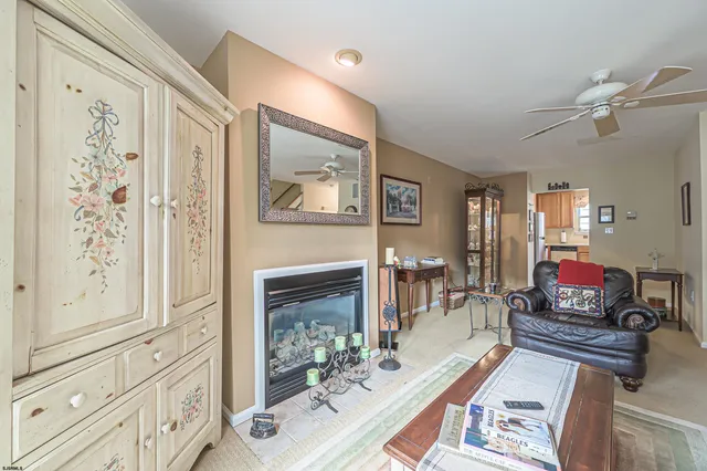 a living room with fireplace furniture and decor