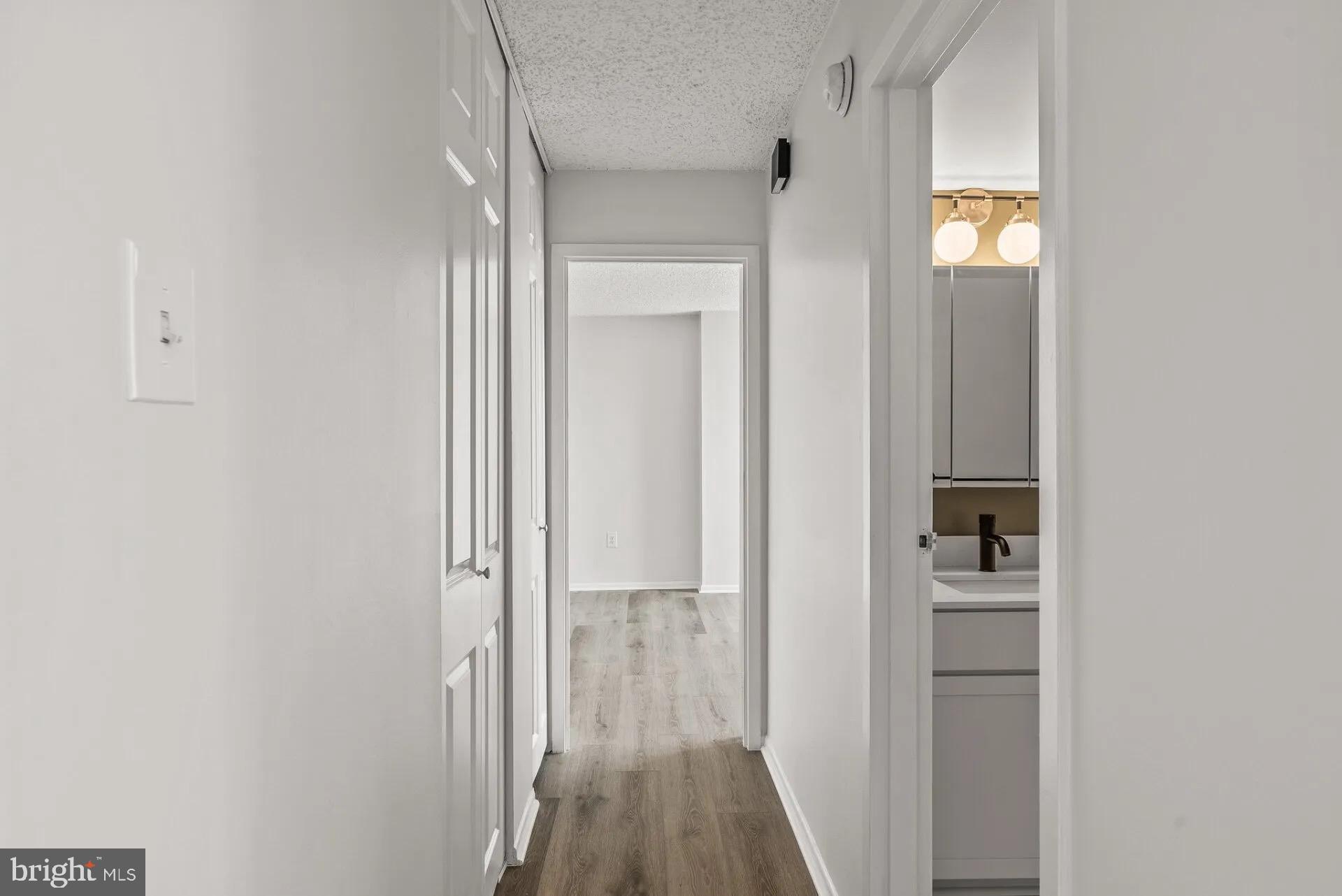 1500 Locust Street, Unit 1B1614 Philadelphia, PA 19102 - Photo 18 of 25 a view of a hallway with wooden floor and closet