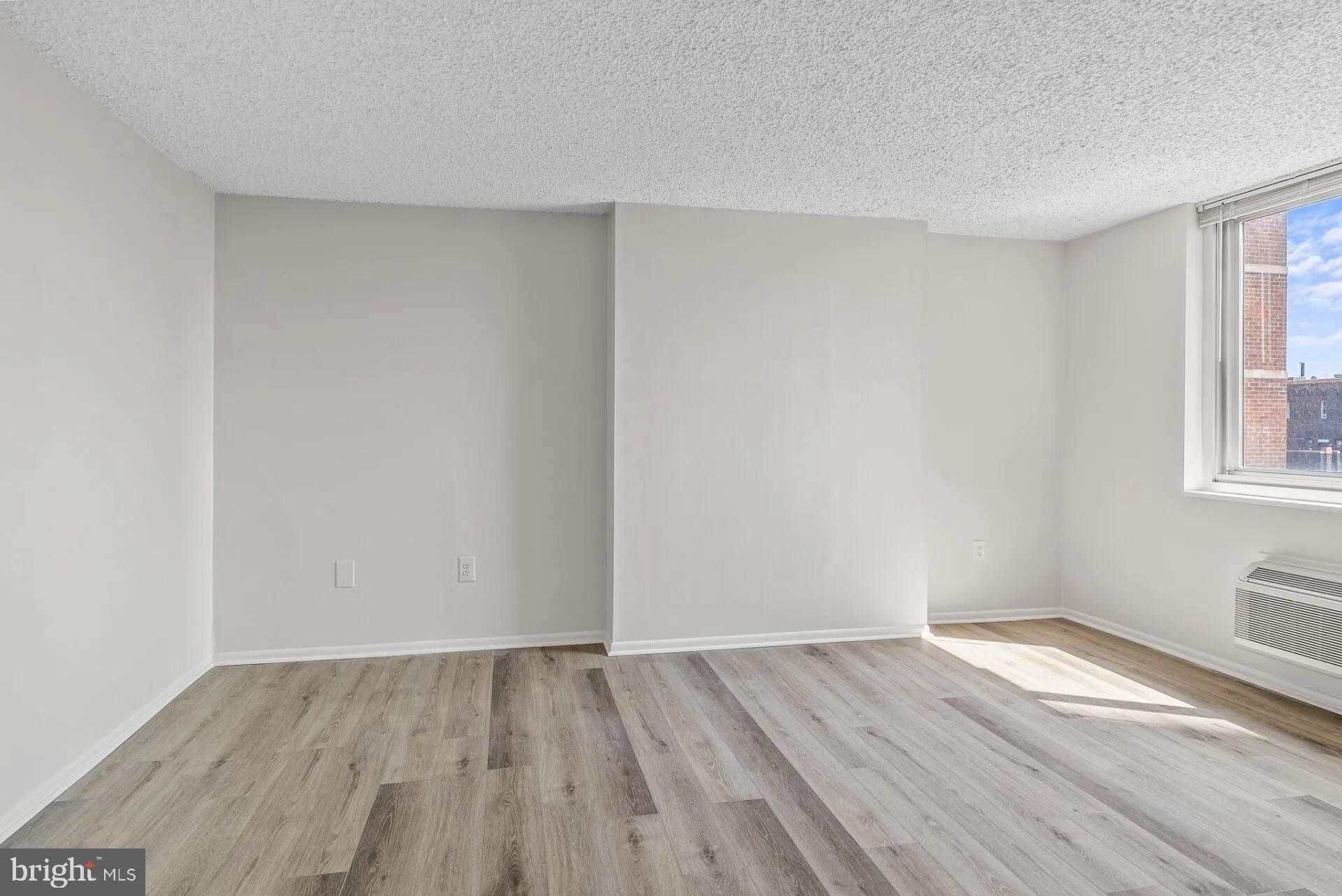 1500 Locust Street, Unit 1B1614 Philadelphia, PA 19102 - Photo 19 of 25 a view of an empty room with wooden floor and a window