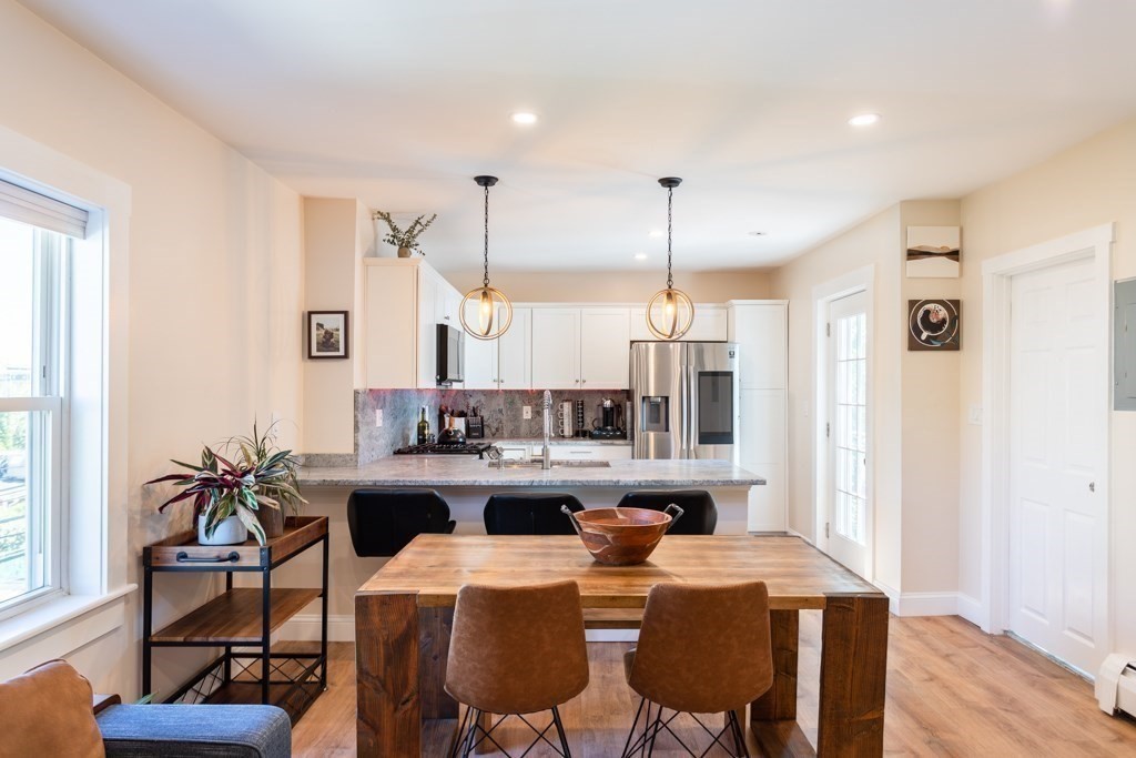 a dining room with furniture and wooden floor