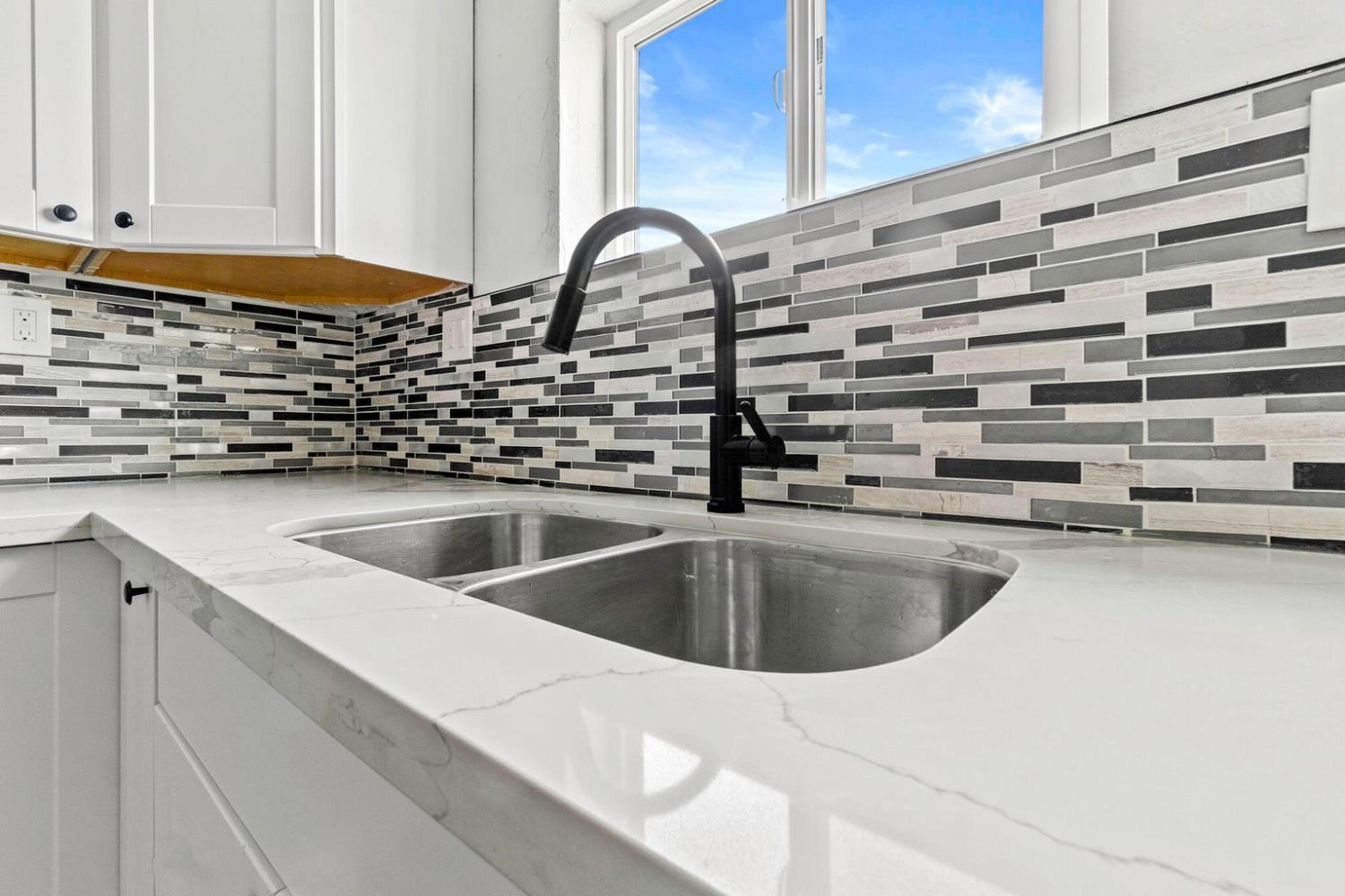 124 East 4th Street Hanford, CA 93230 - Photo 11 of 23 a kitchen with a sink and cabinets