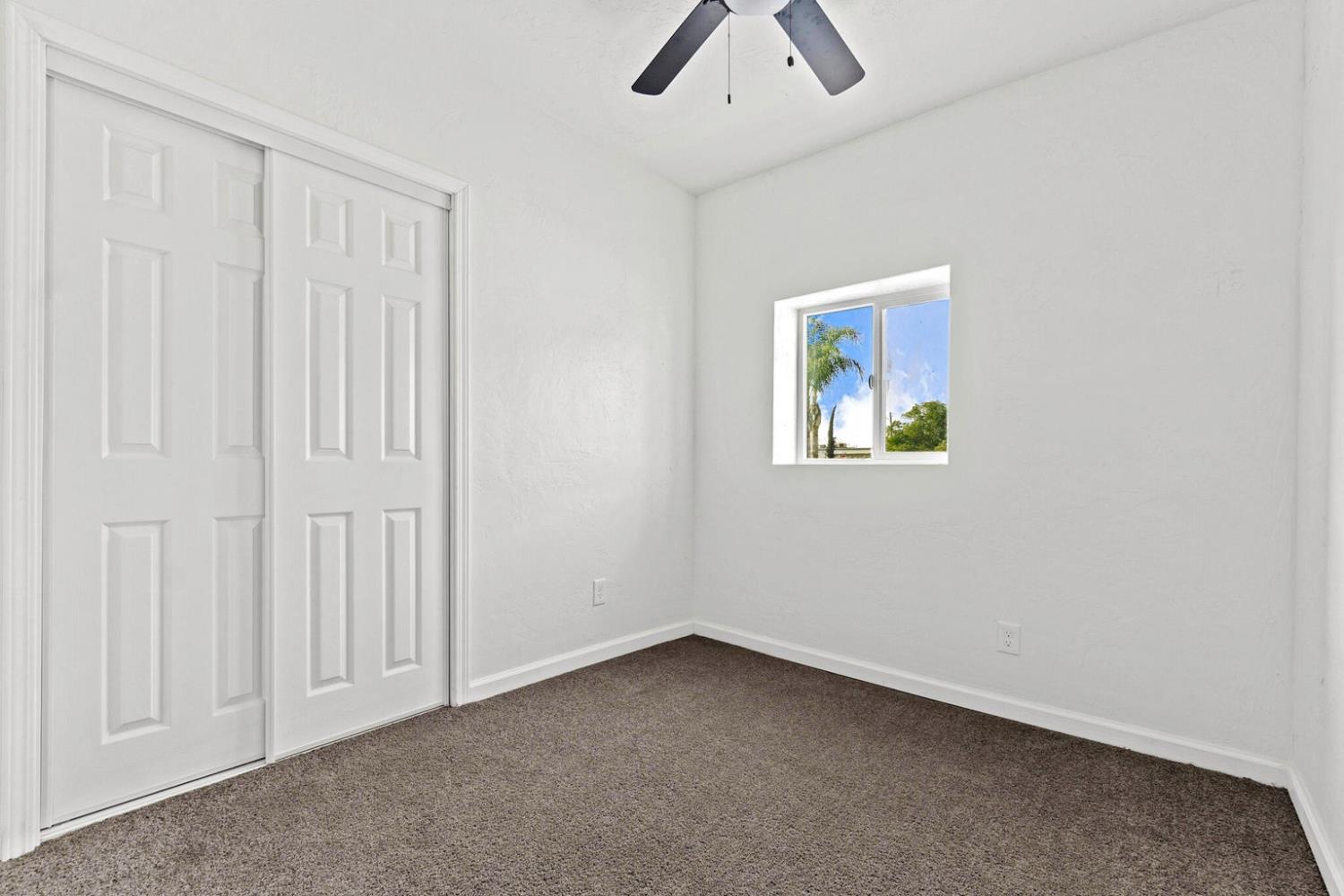 124 East 4th Street Hanford, CA 93230 - Photo 13 of 23 an empty room with a window