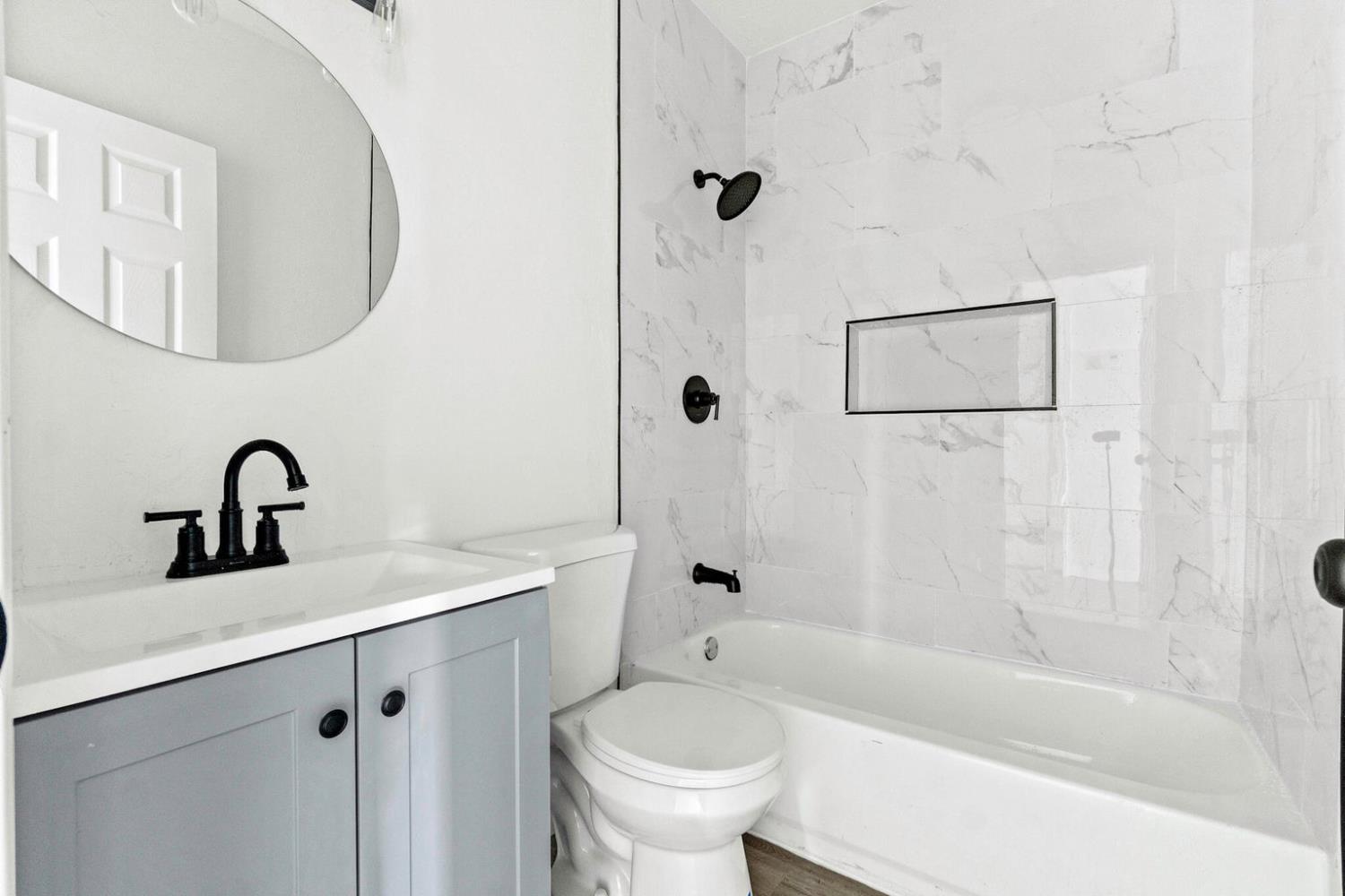 124 East 4th Street Hanford, CA 93230 - Photo 16 of 23 a bathroom with a sink a toilet and shower