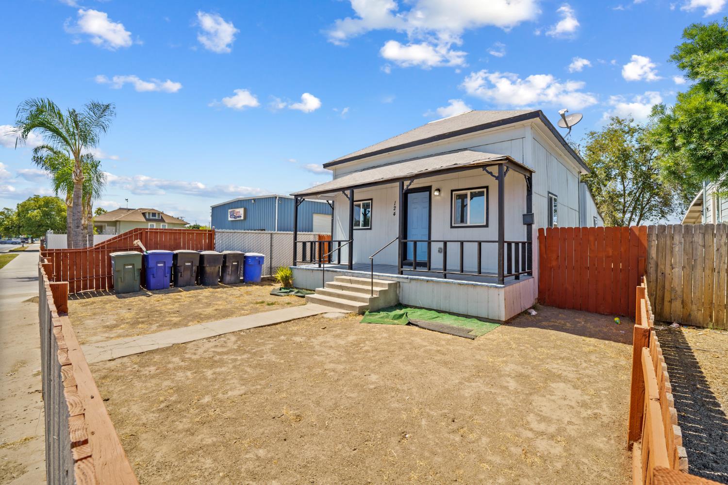 124 East 4th Street Hanford, CA 93230 - Photo 2 of 23 a front view of a house with a yard