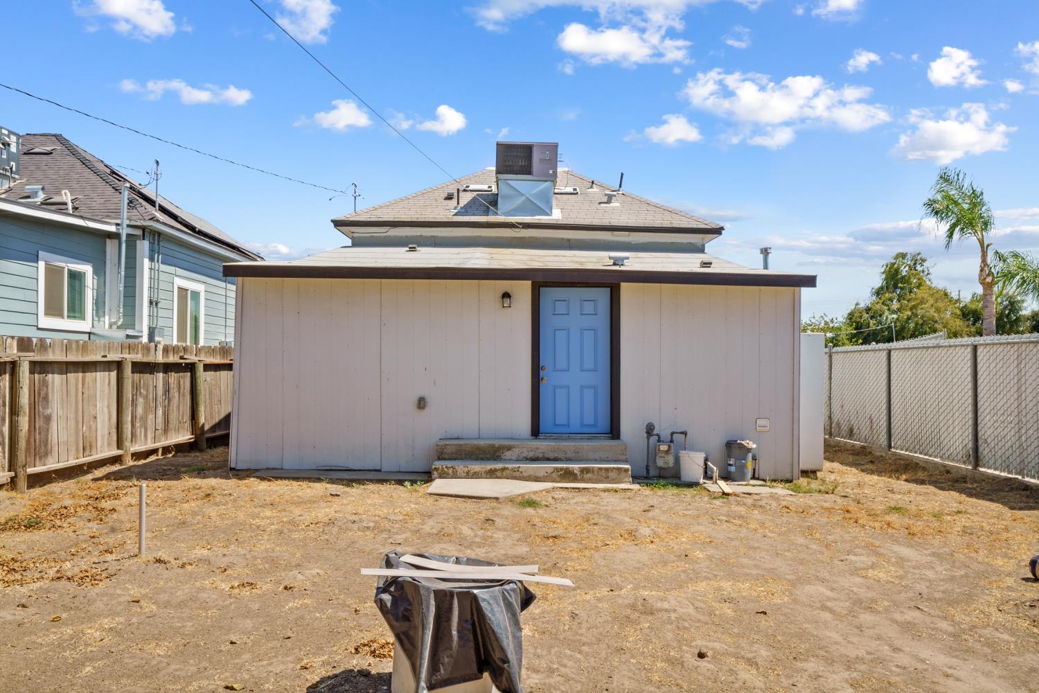 124 East 4th Street Hanford, CA 93230 - Photo 22 of 23 a front view of a house with a yard