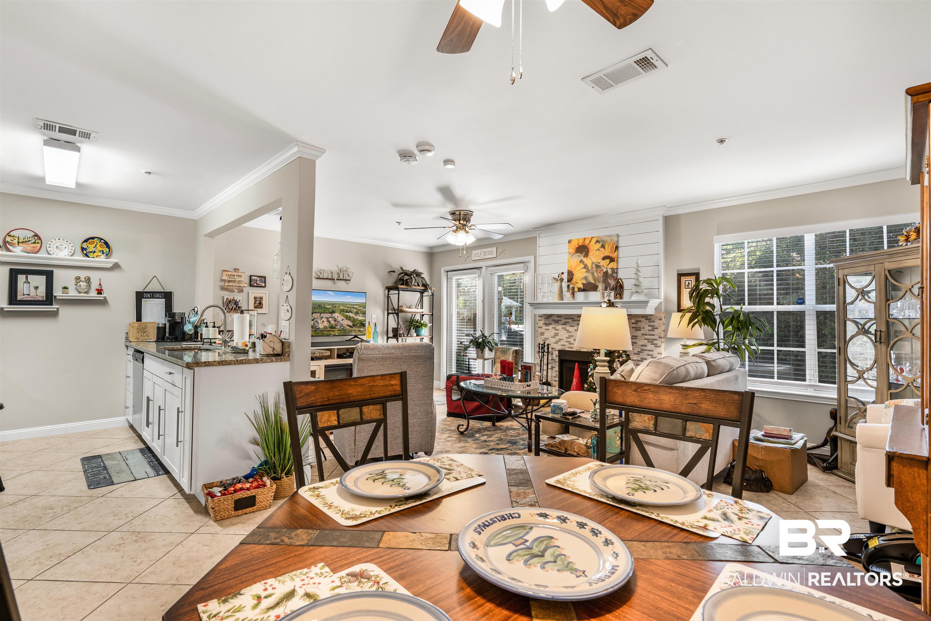 1517 Regency Road, Unit 68 Gulf Shores, AL 36542 - Photo 13 of 43 Tiled dining room with ceiling fan, ornamental molding, and sink