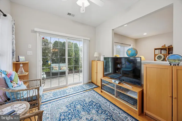 a living room with furniture a flat screen tv and a rug