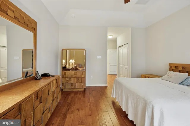 a room with a bed and wooden floor