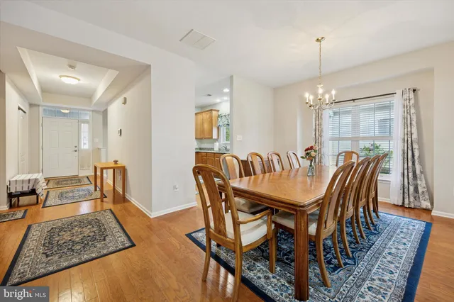 a dining room with furniture and wooden floor