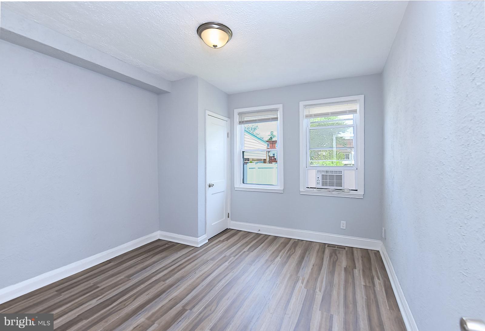 2995 Yorkway, Unit 1 Dundalk, MD 21222 - Photo 12 of 19 an empty room with wooden floor and windows