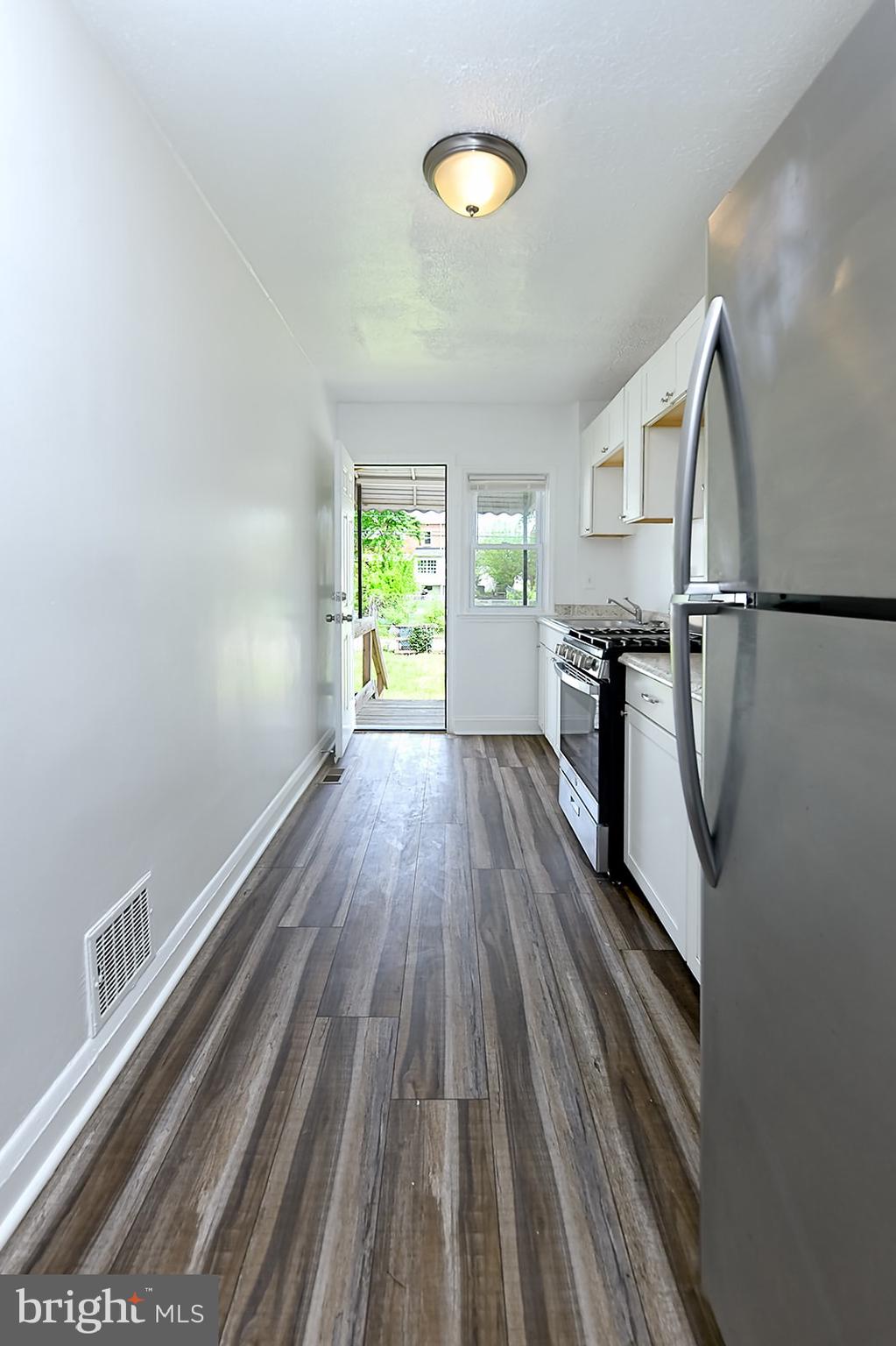 2995 Yorkway, Unit 1 Dundalk, MD 21222 - Photo 4 of 19 a view of a room with wooden floor and staircase