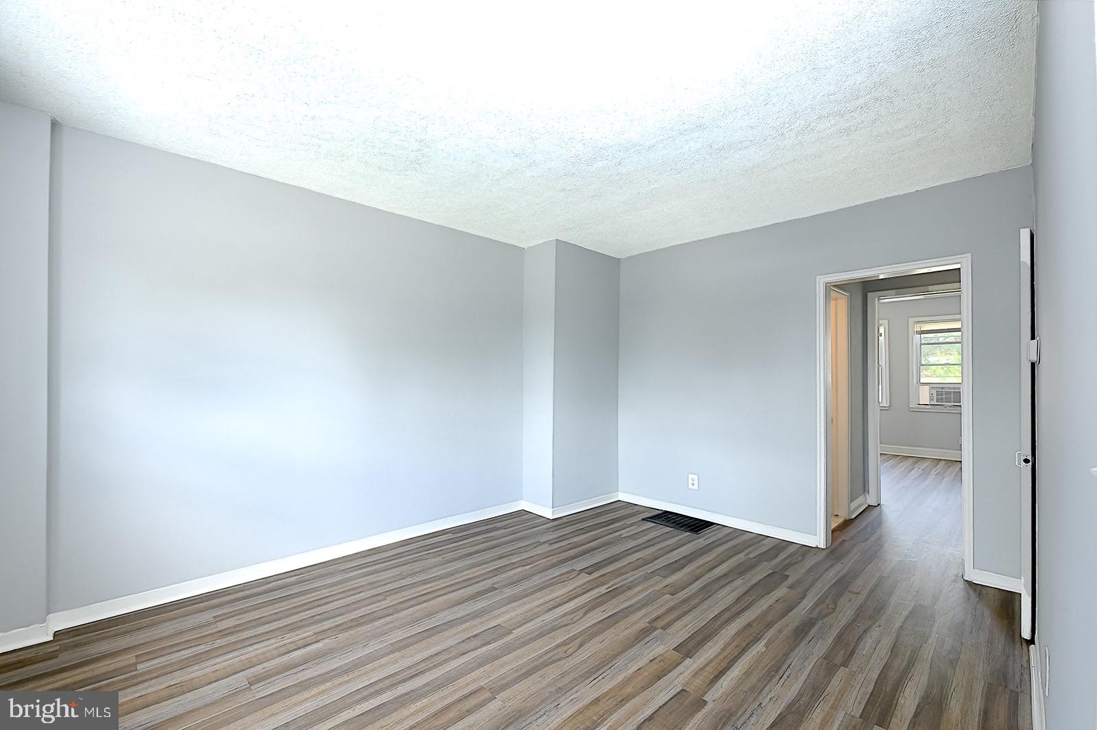 2995 Yorkway, Unit 1 Dundalk, MD 21222 - Photo 6 of 19 a view of wooden floor and windows in a room