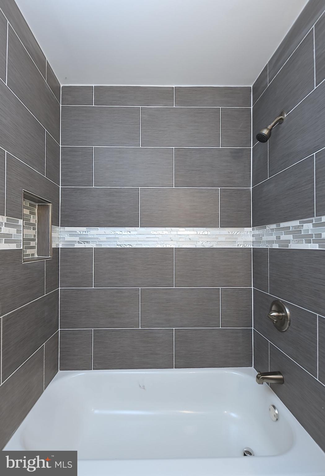 2995 Yorkway, Unit 1 Dundalk, MD 21222 - Photo 10 of 19 a bath tub sitting next to a bathroom