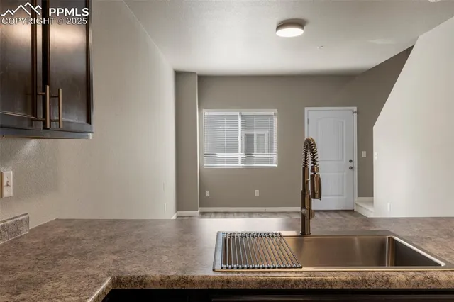 a kitchen with a sink and a window