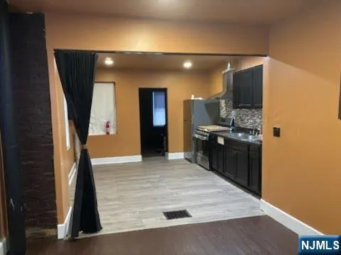 a kitchen with stainless steel appliances a refrigerator and a stove
