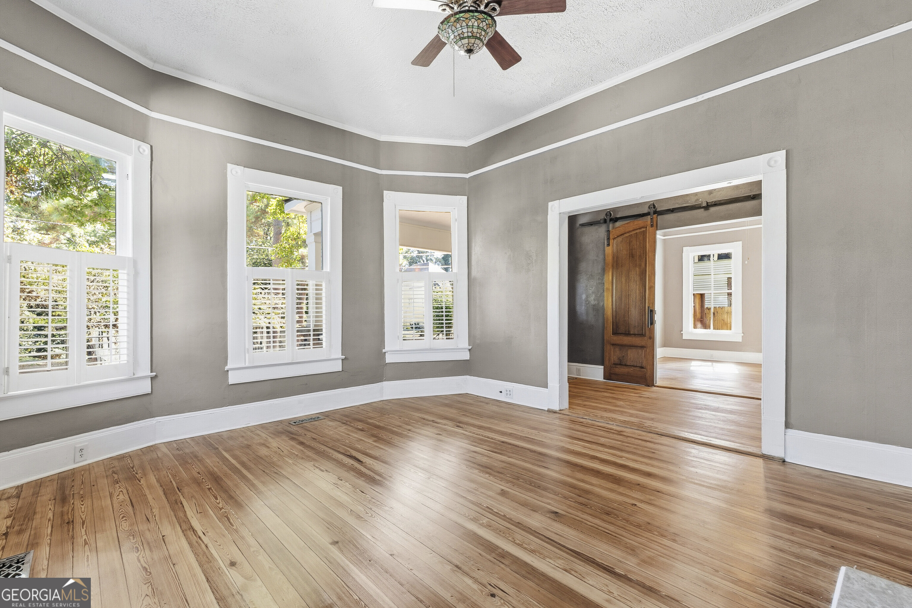 216 Hines Terrace Macon, GA 31204 - Photo 22 of 52 a view of an empty room with a window and wooden floor