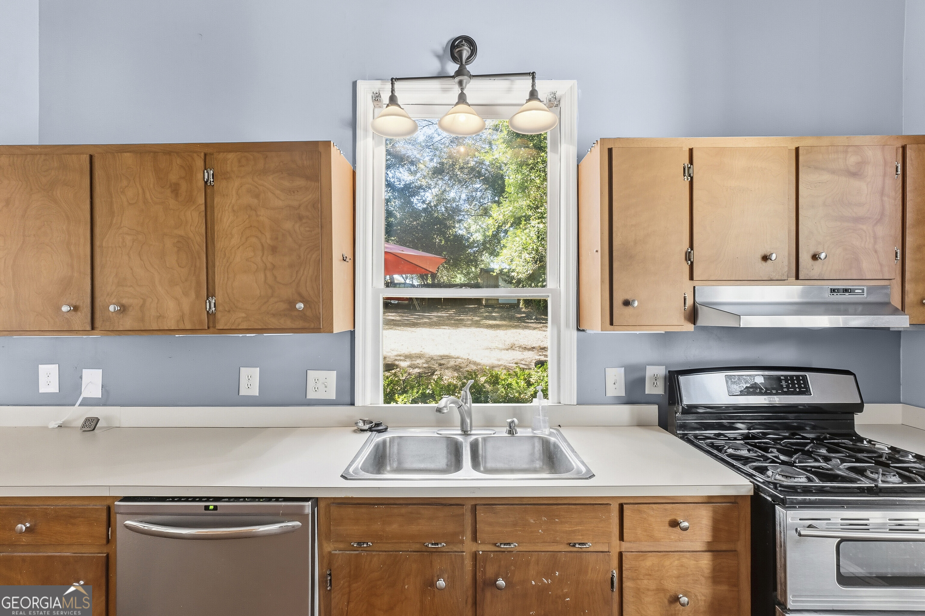 216 Hines Terrace Macon, GA 31204 - Photo 34 of 52 a kitchen with kitchen island granite countertop a sink a counter top space and cabinets
