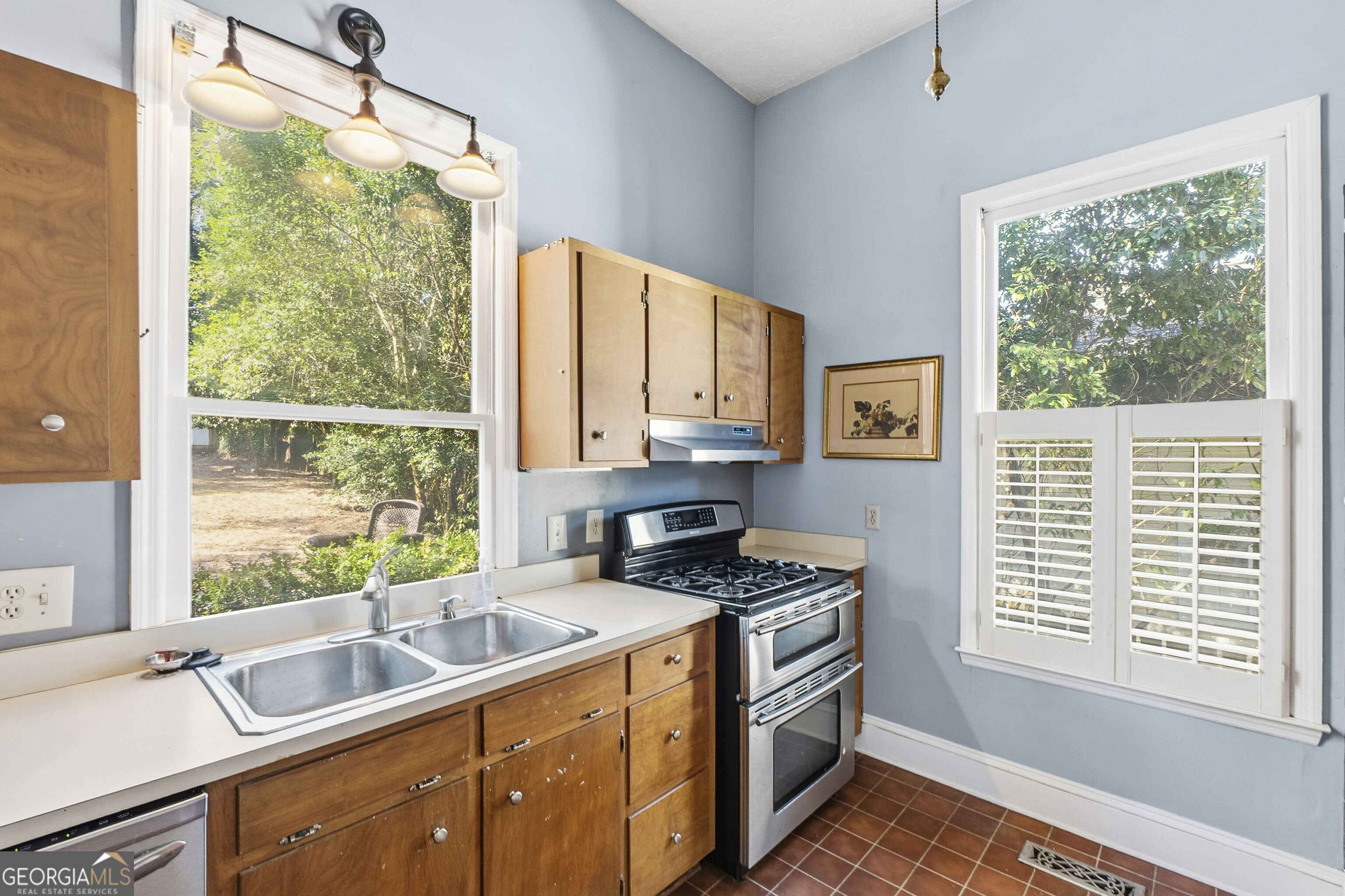 216 Hines Terrace Macon, GA 31204 - Photo 35 of 52 a kitchen that has a sink cabinets appliances and a large window