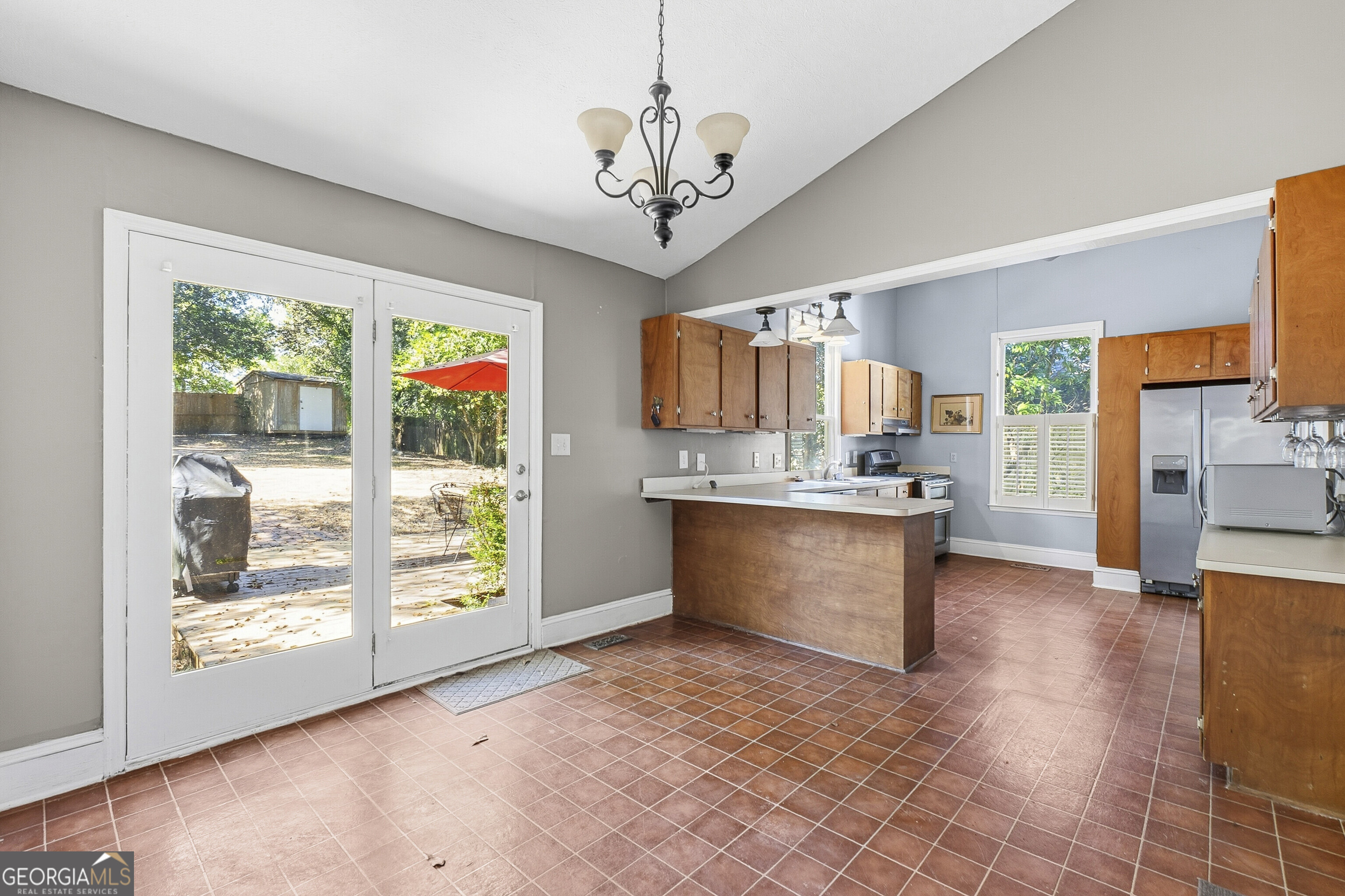 216 Hines Terrace Macon, GA 31204 - Photo 37 of 52 a large kitchen with stainless steel appliances granite countertop a refrigerator a stove top oven a sink and a large window