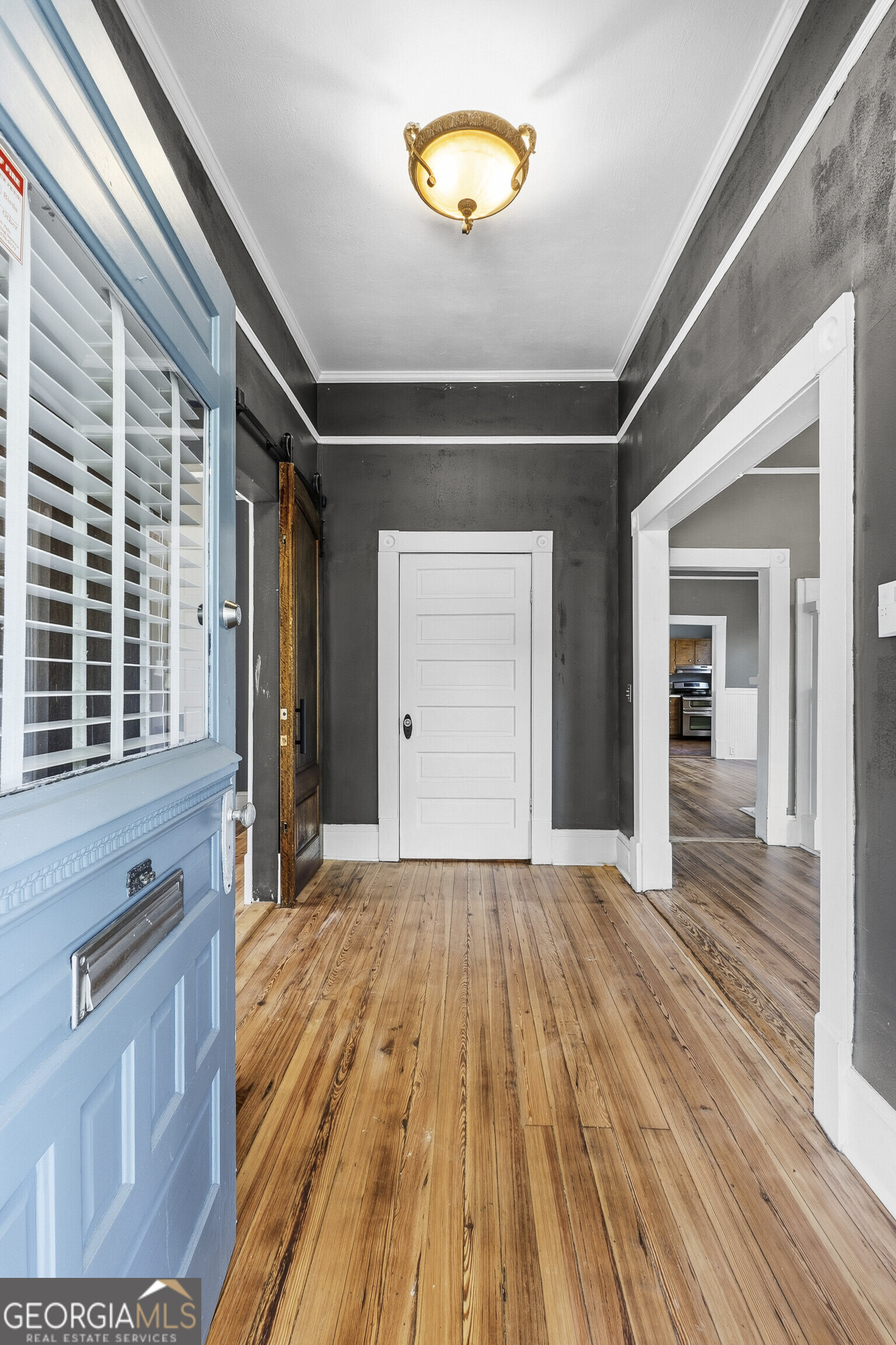 216 Hines Terrace Macon, GA 31204 - Photo 9 of 52 a view of an empty room with wooden floor and a window