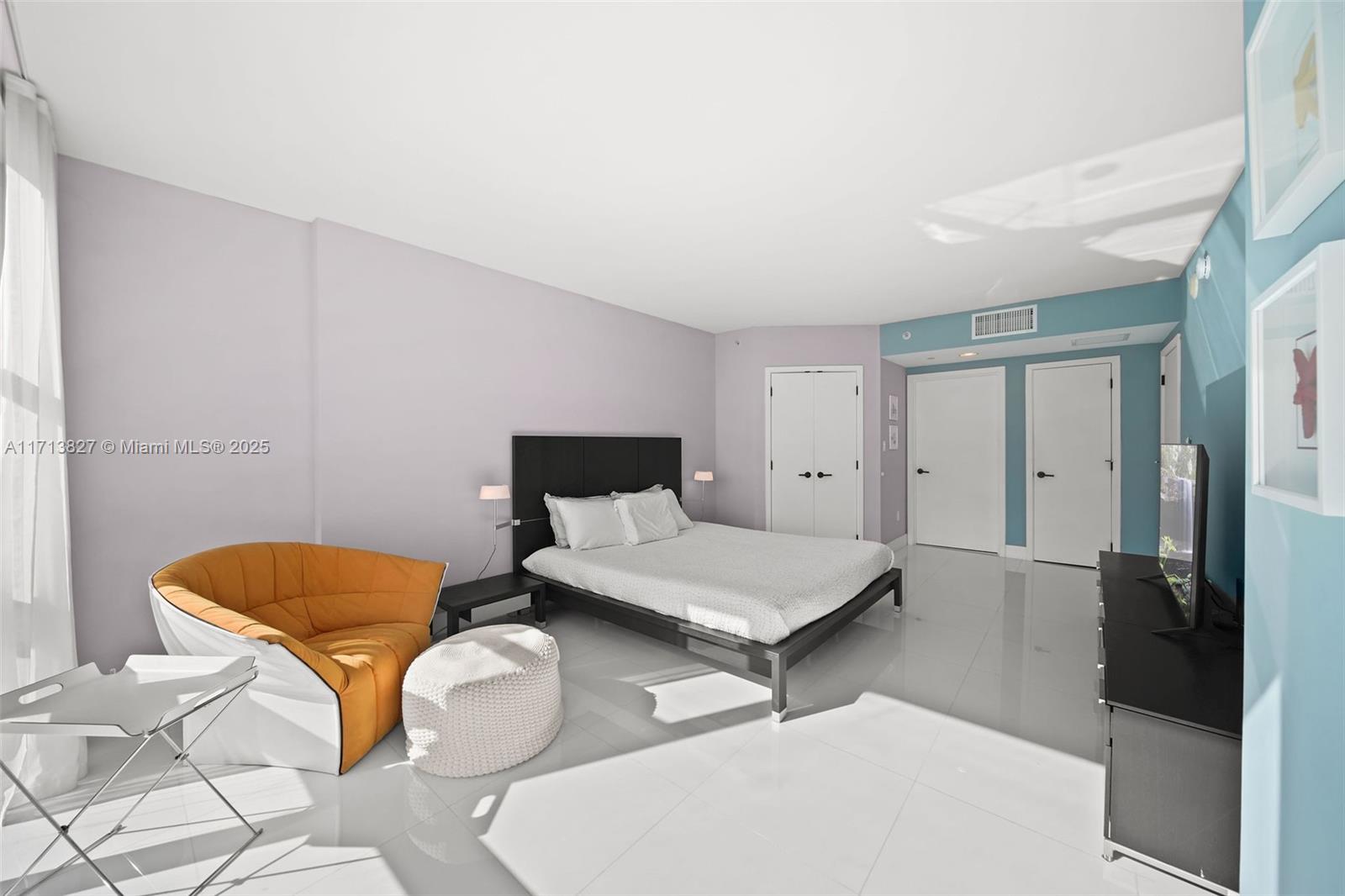 6801 Collins Avenue, Unit 1214 Miami Beach, FL 33141 - Photo 13 of 59 a bedroom with furniture and a lamp