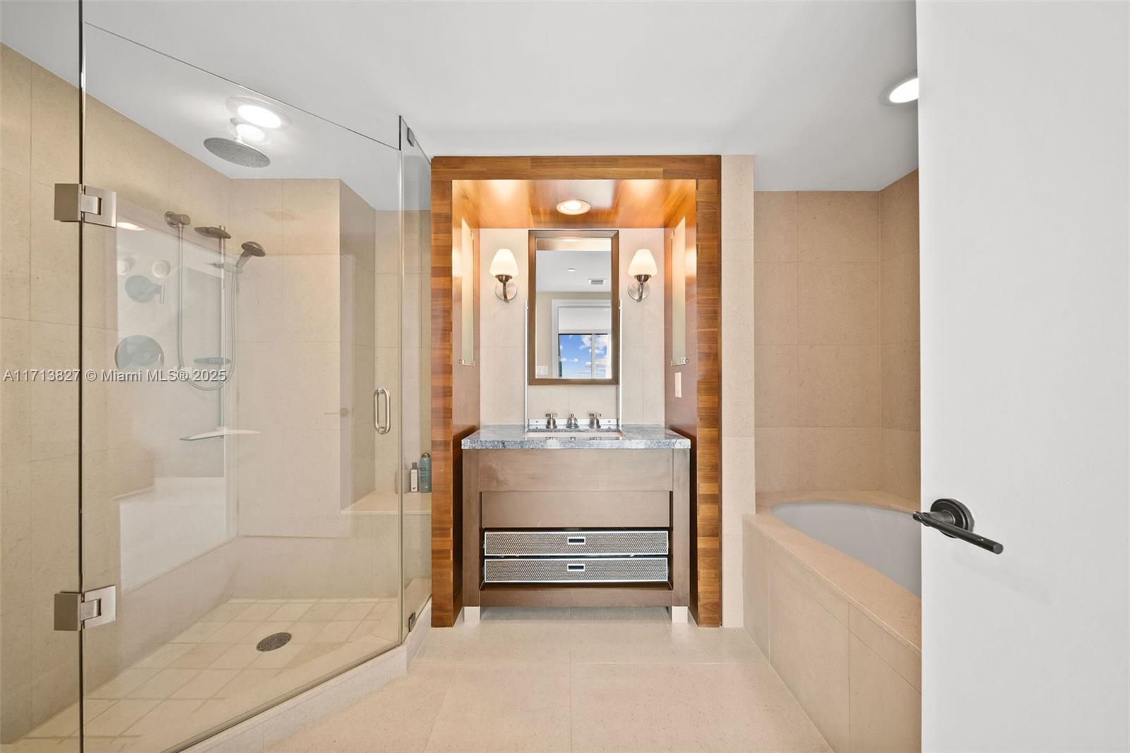 6801 Collins Avenue, Unit 1214 Miami Beach, FL 33141 - Photo 15 of 59 a bathroom with a tub shower and mirror