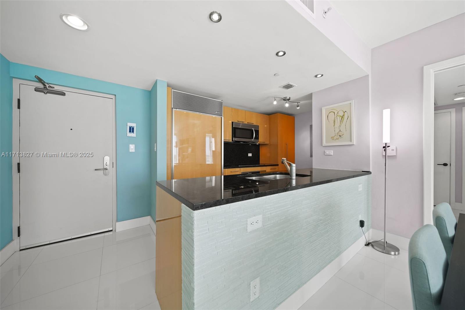 6801 Collins Avenue, Unit 1214 Miami Beach, FL 33141 - Photo 27 of 59 a large white kitchen with a large window