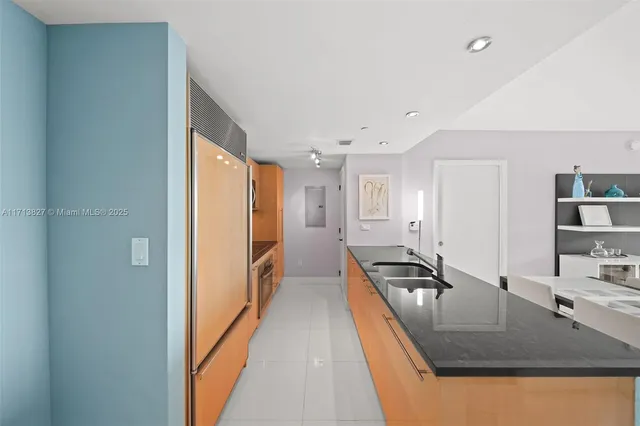 a hallway with white cabinets and couch