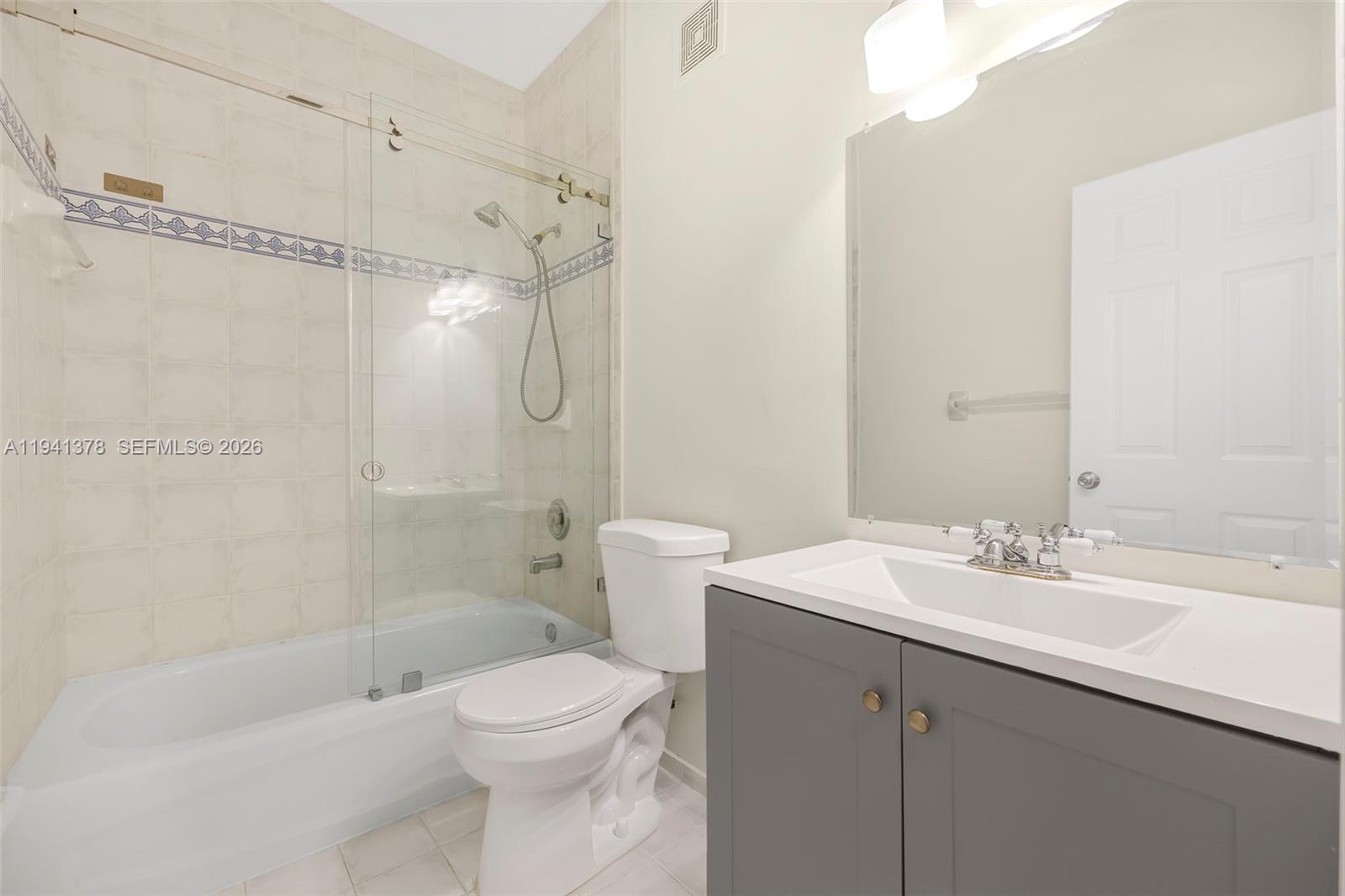 8331 Southwest 124th Avenue, Unit 10414 Miami, FL 33183 - Photo 14 of 24 a bathroom with a sink a toilet and shower