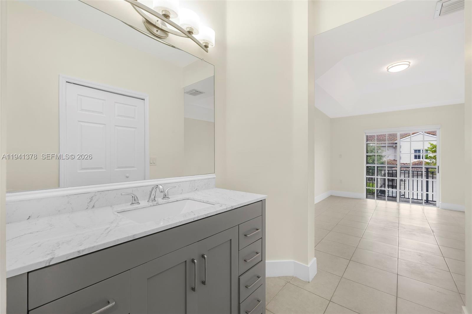 8331 Southwest 124th Avenue, Unit 10414 Miami, FL 33183 - Photo 16 of 24 a bathroom with a sink a vanity and a mirror