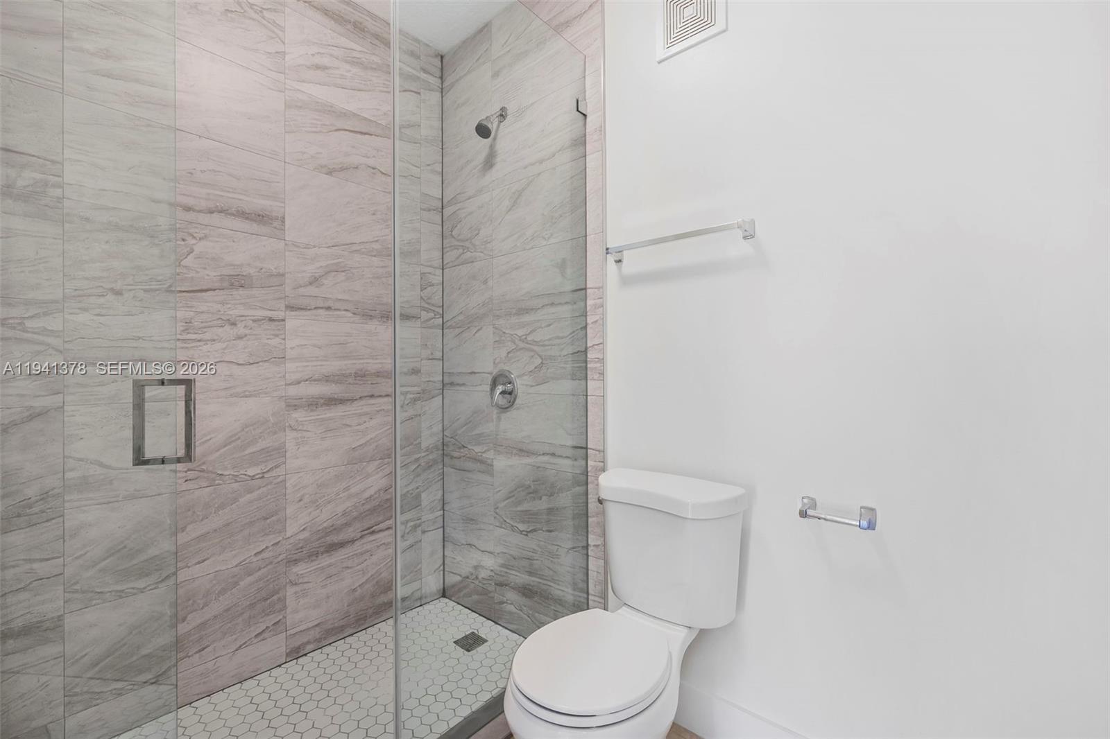 8331 Southwest 124th Avenue, Unit 10414 Miami, FL 33183 - Photo 17 of 24 a white toilet sitting next to a shower