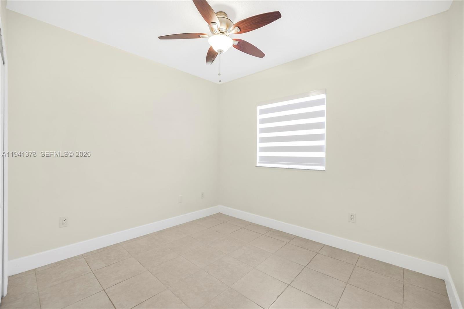 8331 Southwest 124th Avenue, Unit 10414 Miami, FL 33183 - Photo 18 of 24 an empty room with a window and a fan