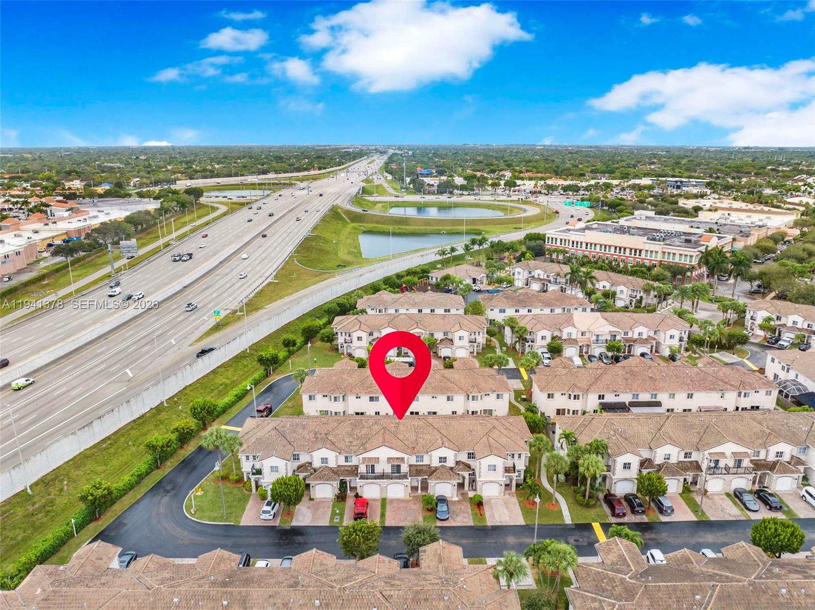 8331 Southwest 124th Avenue, Unit 10414 Miami, FL 33183 - Photo 22 of 24 an aerial view of residential building and parking space