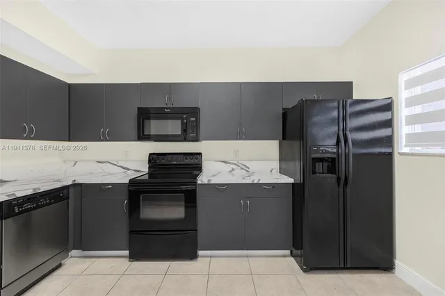 a kitchen with a refrigerator and a stove