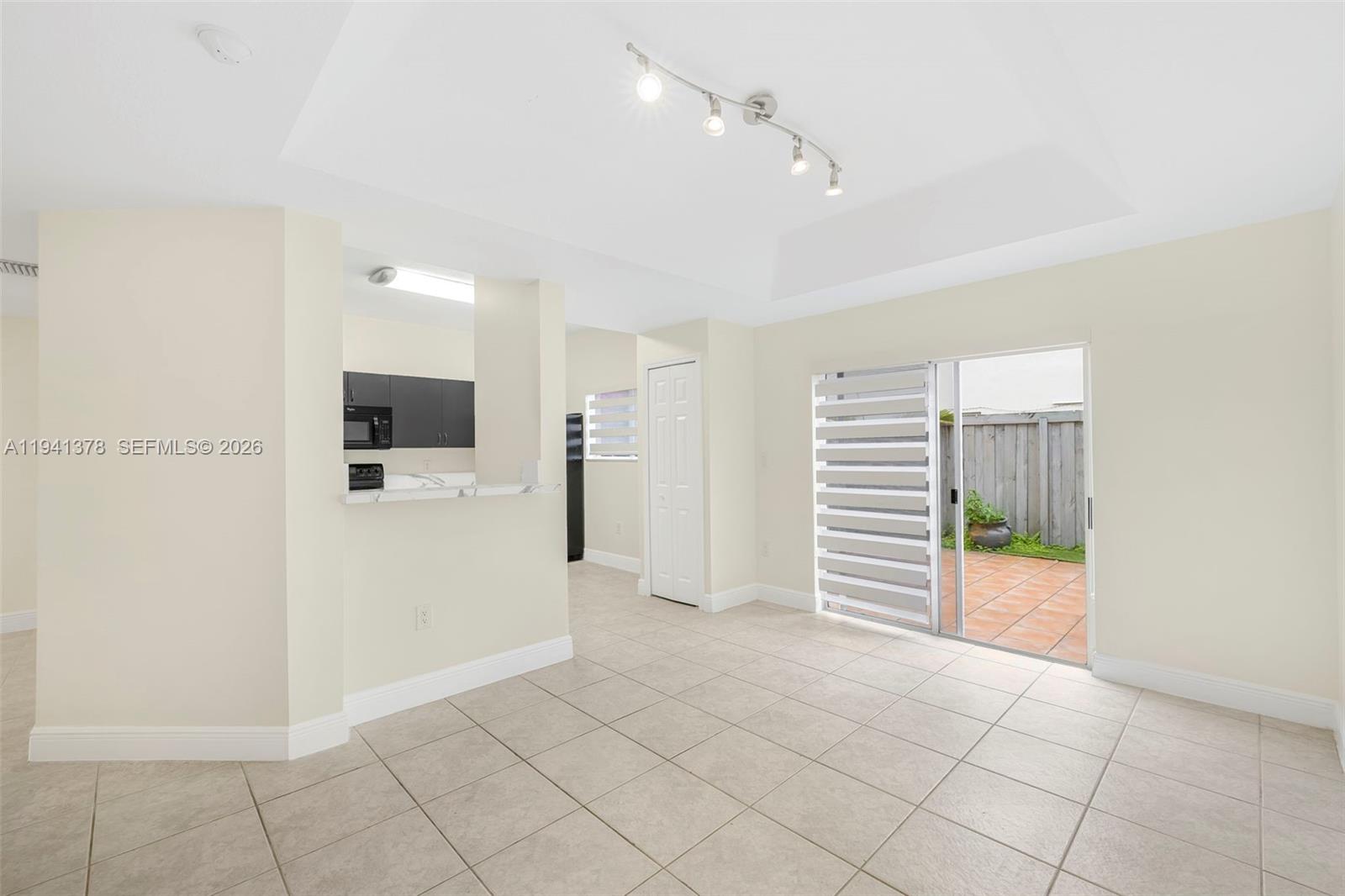 8331 Southwest 124th Avenue, Unit 10414 Miami, FL 33183 - Photo 7 of 24 an empty room with kitchen and a window