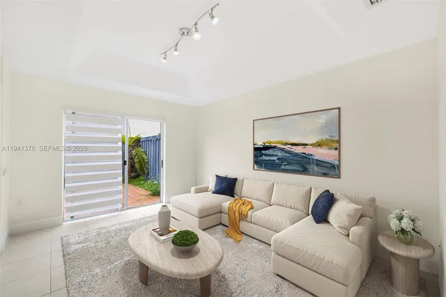 a living room with furniture and a potted plant