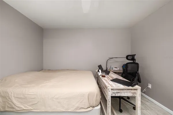 a bed sitting in a bedroom next to a window