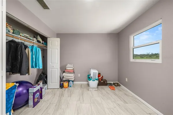 a view of room with wooden floor and furniture