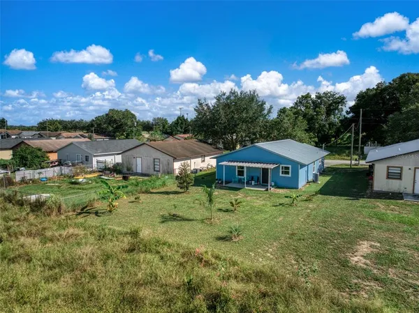a view of a big yard with lots of green space