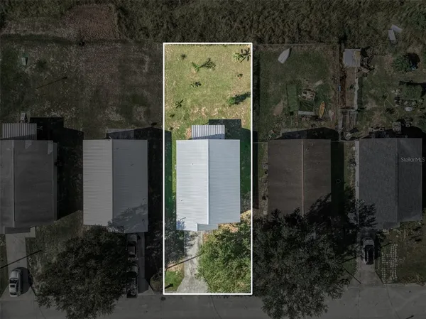an aerial view of a house with a yard