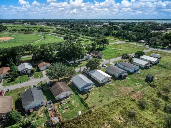 an aerial view of residential houses with outdoor space and swimming pool