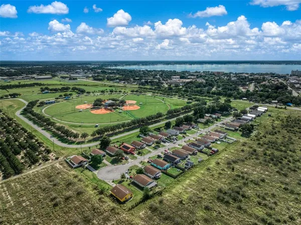 a view of a city with lots of lake and houses in back