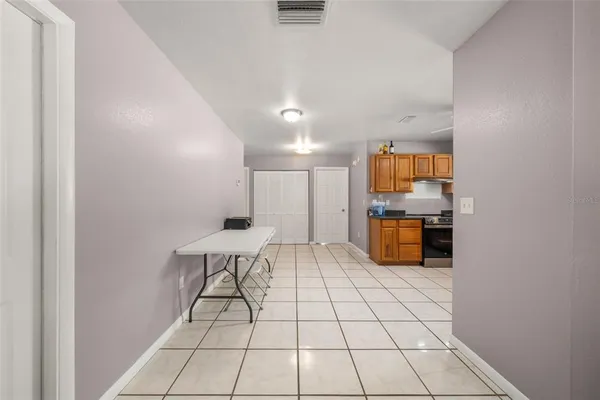 a open kitchen with a sink and white cabinets