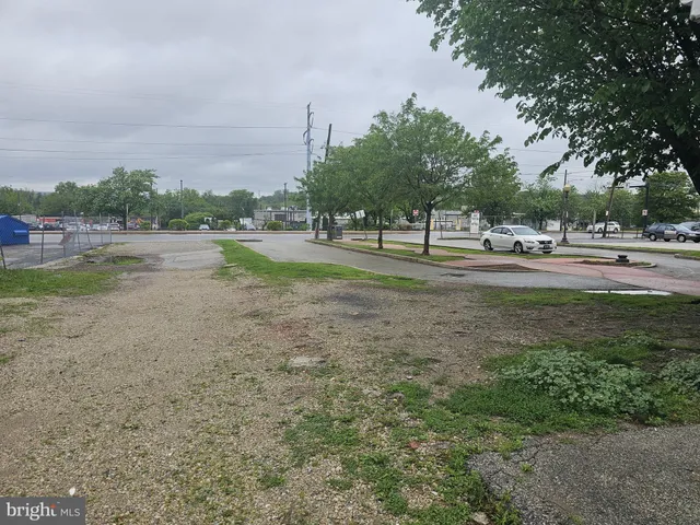 a view of a field with trees in the background