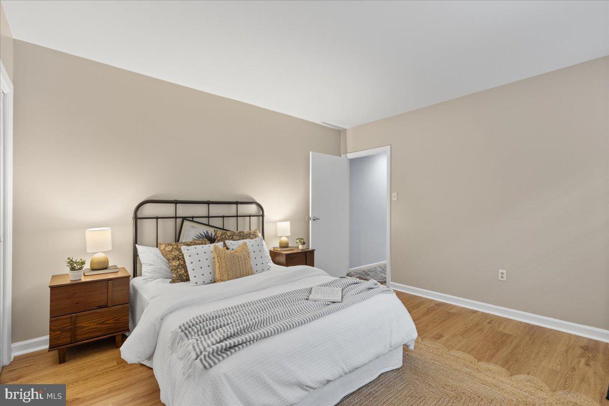 731 South Hanover Street, Unit R2 Baltimore, MD 21230 - Photo 10 of 17 a bedroom with a bed and a night stand
