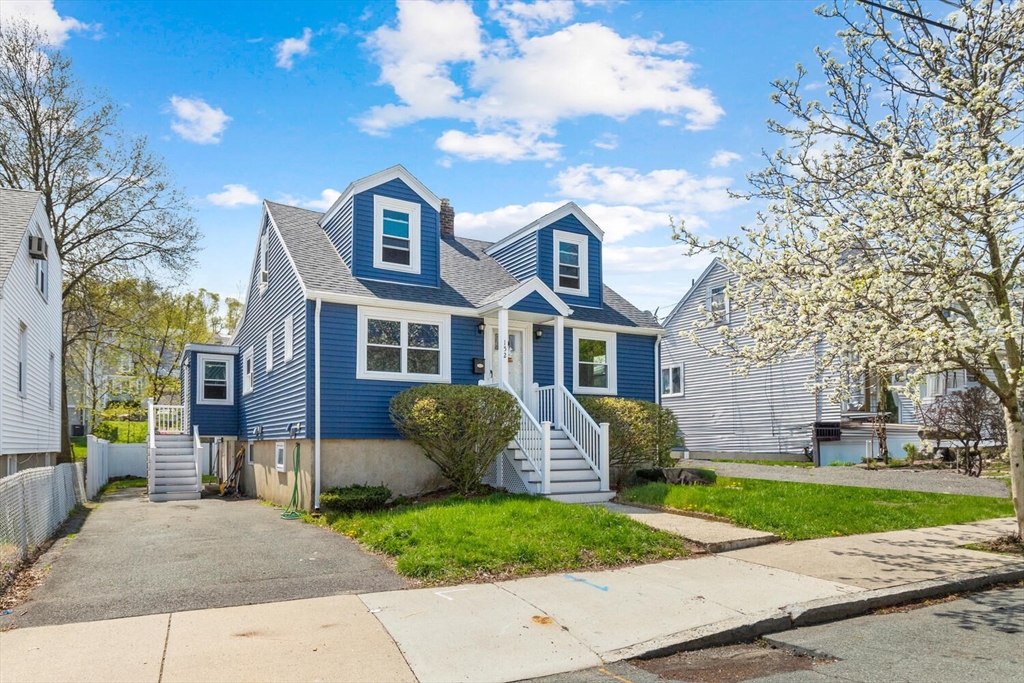 152 Springvale Avenue Everett, MA 02149 - Photo 1 of 30 a front view of a house with a yard and garage
