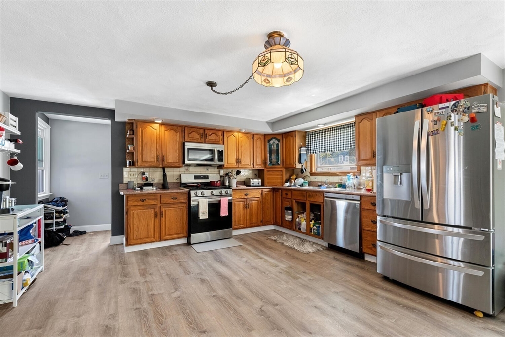 152 Springvale Avenue Everett, MA 02149 - Photo 15 of 30 a kitchen with granite countertop stainless steel appliances and wooden cabinets