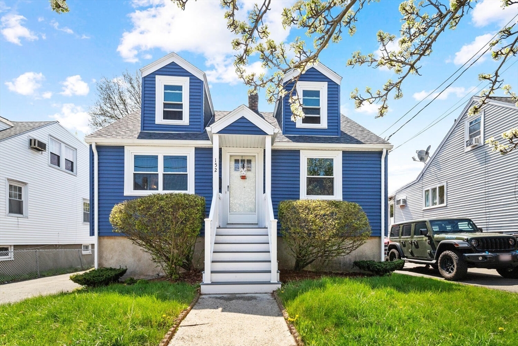 152 Springvale Avenue Everett, MA 02149 - Photo 2 of 30 a view of a brick house with a yard plants and large tree